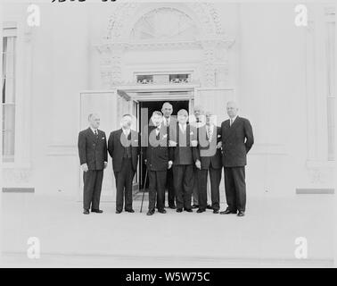 Photograph of President Truman posing outside the renovated White House with officials of the Commission on the Renovation of the Executive Mansion: (from left to right) Major General Glen Edgerton, Executive Director; Representative J. Harry McGregor; Senator Kenneth McKellar, Chairman; Richard Dougherty; the President; Douglas Orr, Vice Chairman; Representative Louis Rabaut; Senator Edward Martin. Stock Photo