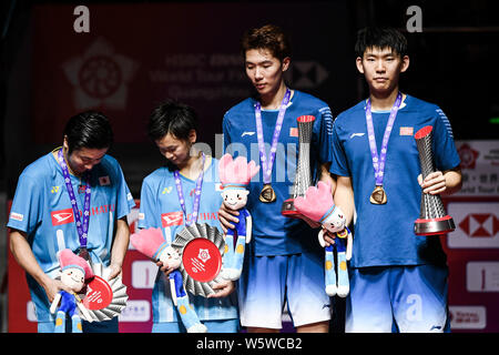 Hiroyuki Endo and Yuta Watanabe of Japan, left, and Li Junhui and Liu Yuchen of China pose with their trophies after their Men's Doubles final match d Stock Photo