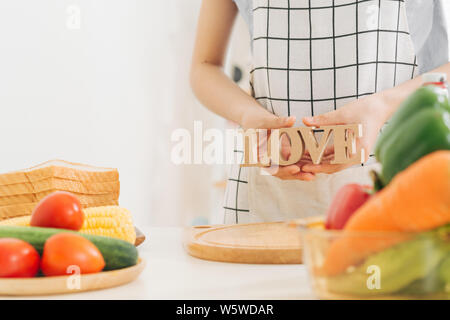 Young trendy woman cooking healthy food in the morning Stock Photo