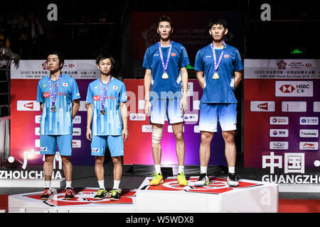 Hiroyuki Endo and Yuta Watanabe of Japan, left, and Li Junhui and Liu Yuchen of China pose with their trophies after their Men's Doubles final match d Stock Photo