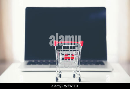 shopping cart with laptop on the desk, online shopping concept Stock Photo