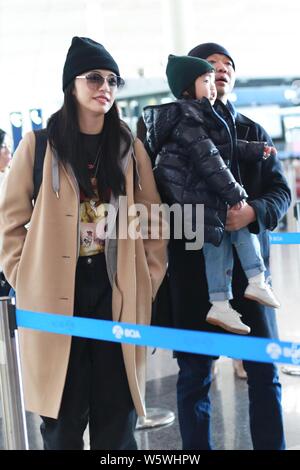 Chinese actress Yao Chen, her husband and their son are pictured at the Beijing Capital International Airport in Beijing, China, 6 December 2018. Stock Photo