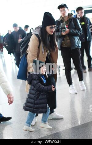 Chinese actress Yao Chen, her husband and their son are pictured at the Beijing Capital International Airport in Beijing, China, 6 December 2018. Stock Photo