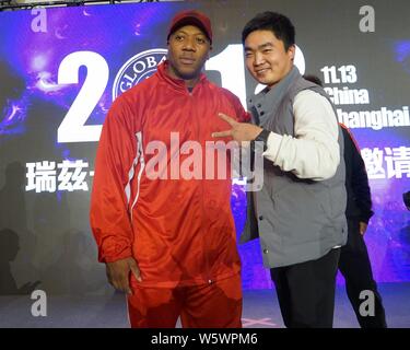 Jamaican-American IFBB professional bodybuilder Shawn Rhoden, left, poses for photos with a participant during a bodybuilding competition in Shanghai, Stock Photo