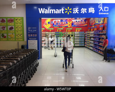 --FILE--Customers walk into a supermarket of Walmart in Wuhan city, central China's Hubei province, 6 July 2018.   The US retailer Walmart Inc is seek Stock Photo