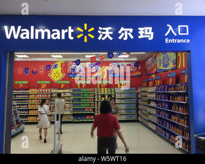 --FILE--Customers walk into a supermarket of Walmart in Wuhan city, central China's Hubei province, 6 July 2018.   The US retailer Walmart Inc is seek Stock Photo