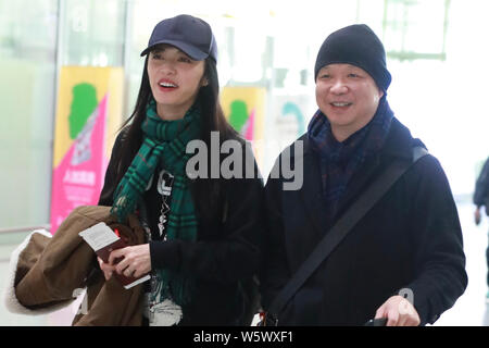 Chinese actress Yao Chen, left, and her husband are pictured at the Beijing Capital International Airport in Beijing, China, 19 November 2018. Stock Photo