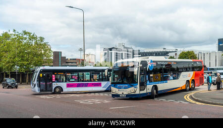 Two single-decker buses, Stagecoach and Firstbus, leaving Buchanan Bus Station in Glasgow city centre, Scotland Stock Photo