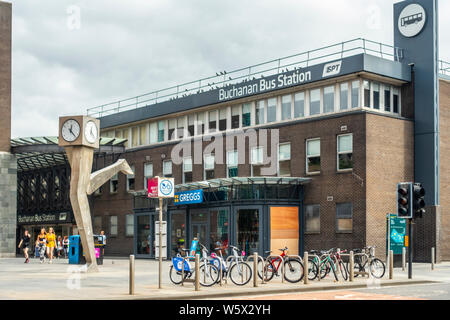 Exterior of and entrance to Buchanan Bus Station with the Clyde Clock / Running Time (George Wylie) and a Greggs cafe; Glasgow city centre, Scotland. Stock Photo