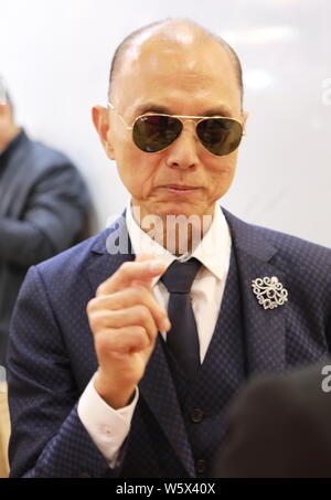 Renowned shoe designer Jimmy Choo is pictured at the stand of luxury company Genavant during the First China International Import Expo (CIIE) and the Stock Photo