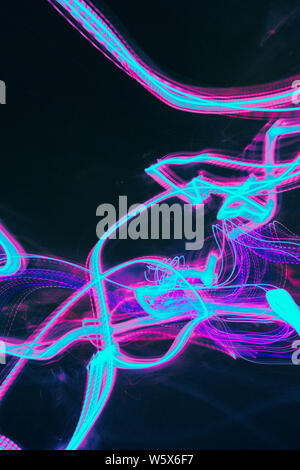 Variety of abstract blue, purble and pink light trails on a black background. Stock Photo