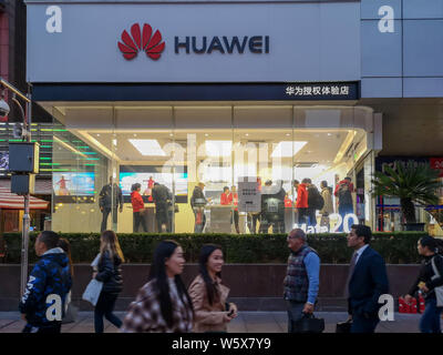 --FILE--Pedestrians walk past a store of Huawei in Shanghai, China, 12 November 2018.   Chinese communications giant Huawei Technologies has penned a Stock Photo