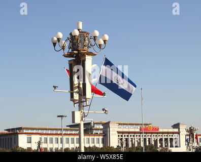 Chinese and El Salvador national flags flutter on the lamppost in front of the Tian'anmen Rostrum during the visit of El Salvador's President Salvador Stock Photo