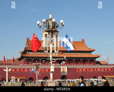 Chinese and El Salvador national flags flutter on the lamppost in front of the Tian'anmen Rostrum during the visit of El Salvador's President Salvador Stock Photo