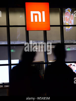 --FILE--Pedestrians walk past a Xiaomi store in Shenyang city, northeast China's Liaoning province, 11 October 2018.   Xiaomi is scheduled to open its Stock Photo
