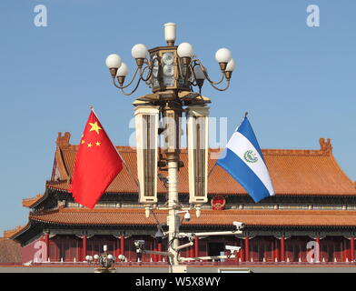 Chinese and El Salvador national flags flutter on the lamppost in front of the Tian'anmen Rostrum during the visit of El Salvador's President Salvador Stock Photo