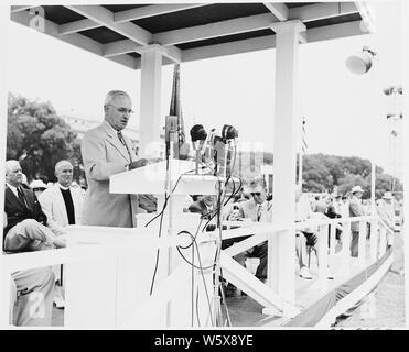 President Truman attends ceremonies celebrating the 100th anniversary of the Washington Monument. He is at podium in this photo.