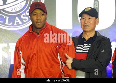 Jamaican-American IFBB professional bodybuilder Shawn Rhoden, left, poses for photos with a participant during a bodybuilding competition in Shanghai, Stock Photo