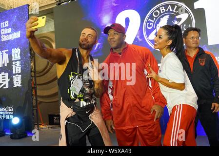 Jamaican-American IFBB professional bodybuilder Shawn Rhoden, center, poses for photos with participants during a bodybuilding competition in Shanghai Stock Photo