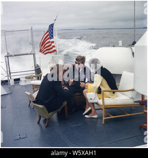 President Vacations in Maine. Under Secretary of the Navy Paul Fay, President Kennedy, Patricia Kennedy Lawford. Boothbay Harbor, ME, aboard the US Coast Guard Cutter Guardian 1. Stock Photo