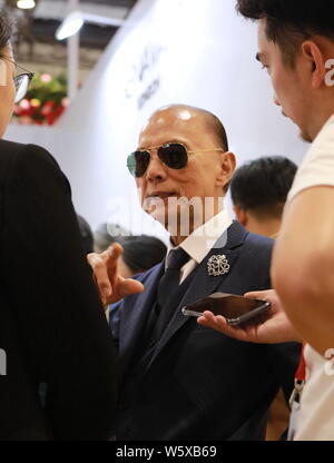 Renowned shoe designer Jimmy Choo is pictured at the stand of luxury company Genavant during the First China International Import Expo (CIIE) and the Stock Photo