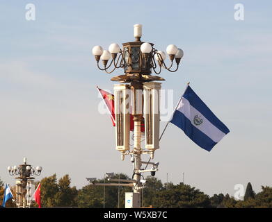 Chinese and El Salvador national flags flutter on the lamppost in front of the Tian'anmen Rostrum during the visit of El Salvador's President Salvador Stock Photo