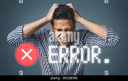 Young man in stress holding his head with hands Stock Photo