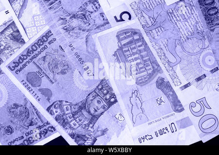 Various banknotes from different countries close-up (Belarusian rubles, Georgian lari, Polish zloty, Israeli shekels, Vietnamese dongs). Money backgro Stock Photo