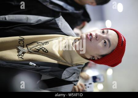 Chinese actor Dylan Wang Hedi, center, of the new lineup of Chinese boy group F4 is surrounded by crowds of fans as he arrives at an airport in Shangh Stock Photo