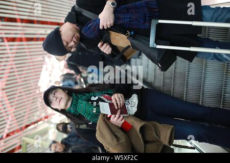 Chinese actress Yao Chen, left, and her husband are pictured at the Beijing Capital International Airport in Beijing, China, 19 November 2018. Stock Photo