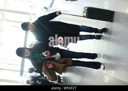 Chinese actress Yao Chen, left, and her husband are pictured at the Beijing Capital International Airport in Beijing, China, 19 November 2018. Stock Photo