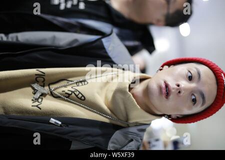 Chinese actor Dylan Wang Hedi, center, of the new lineup of Chinese boy group F4 is surrounded by crowds of fans as he arrives at an airport in Shangh Stock Photo