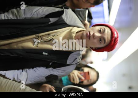 Chinese actor Dylan Wang Hedi, center, of the new lineup of Chinese boy group F4 is surrounded by crowds of fans as he arrives at an airport in Shangh Stock Photo