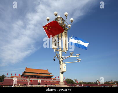 Chinese and El Salvador national flags flutter on the lamppost in front of the Tian'anmen Rostrum during the visit of El Salvador's President Salvador Stock Photo