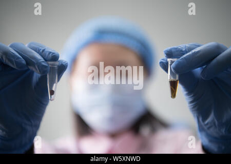 A Chinese medical worker shows human embryos as she performs genetic testing on fertilized eggs or embryos for test-tube babies in the lab of Shanxi P Stock Photo