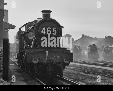 Nostalgic recreation of a steam era railway shed scene, in black and white, emphasizing those past glory days.