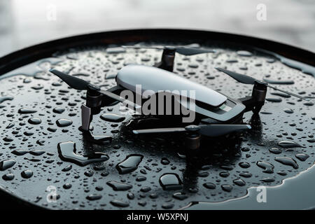 Close up of drone quadcopter on black wet backround. remote controlled wireless quadcopter drone with video and photo camera for aerial photography Stock Photo