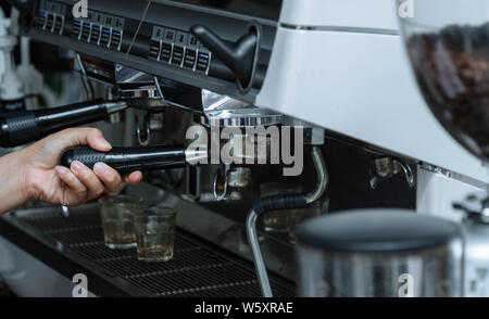 Indoor.A coffee making machine.Coffee machine operating platform. Hold the handle of the coffee machine. To clear the coffee machine. Stock Photo