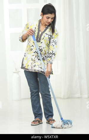 Indian young woman wiping floor Stock Photo