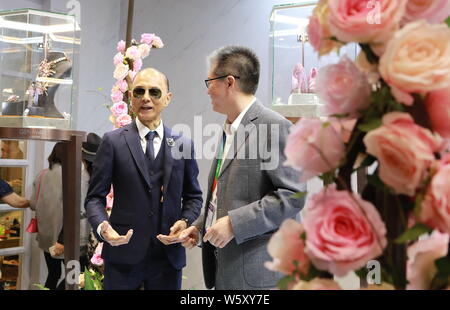 Renowned shoe designer Jimmy Choo is pictured at the stand of luxury company Genavant during the First China International Import Expo (CIIE) and the Stock Photo