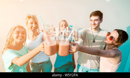 Group of happy young friends having fun and drinking smoothies Stock Photo