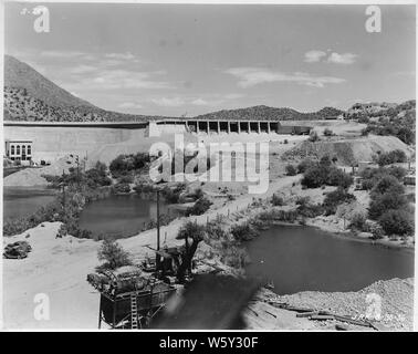 Stewart Mountain Dam. View from downstream side of dam showing completed spillway channel.; Scope and content:  Photograph from Volume One of a series of photo albums documenting the construction of Roosevelt Dam, Stewart Dam, and other related work on the Salt River Project in Arizona. Stock Photo