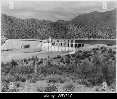 Stewart Mountain Dam. View from right abutment showing completed spillway channel.; Scope and content:  Photograph from Volume One of a series of photo albums documenting the construction of Roosevelt Dam, Stewart Dam, and other related work on the Salt River Project in Arizona. Stock Photo