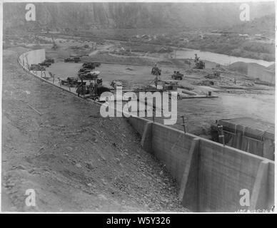 Stewart Mountain Dam. View looking downstream showing backfill along left wall. Note excavation for downstream cut-off wall.; Scope and content:  Photograph from Volume One of a series of photo albums documenting the construction of Roosevelt Dam, Stewart Dam, and other related work on the Salt River Project in Arizona. Stock Photo