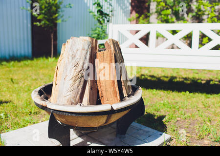Close-up, roaring fire with blurred flames from wood logs in a stone firepit. Stock Photo