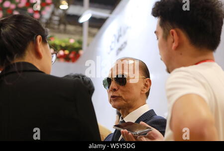 Renowned shoe designer Jimmy Choo is pictured at the stand of luxury company Genavant during the First China International Import Expo (CIIE) and the Stock Photo