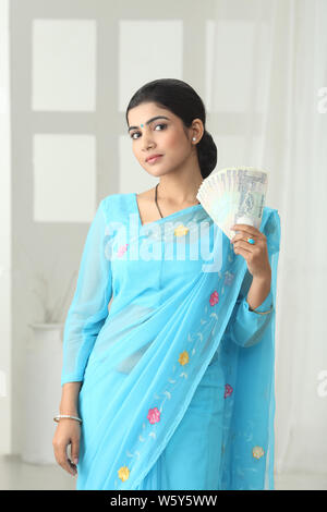 Woman showing one hundred rupee banknotes Stock Photo