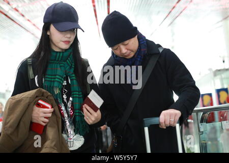 Chinese actress Yao Chen, left, and her husband are pictured at the Beijing Capital International Airport in Beijing, China, 19 November 2018. Stock Photo