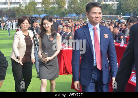 --FILE--Richard Liu Qiangdong, right, Chairman and CEO of JD.com, and his wife Zhang Zetian, also known as milk tea girl, attend the 90th anniversary Stock Photo