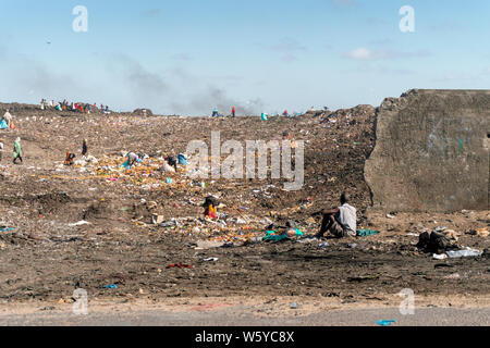 People collecting resources from a huge garbage dump in the capital city of Mozambique - Maputo. Stock Photo